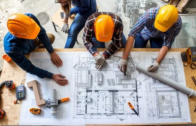 Engineers looking at blueprint